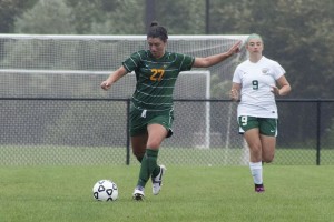 Northern Michigan University sophomore mid fielder Gabriella Garza (27) goes in for the kick vs. Memidji State University freshman forward Bayley Ertl (9) (Photo: Anthony Viola) 