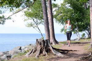 Sophomore Rachel Butler, majoring in the management of health and fitness, exercises along the shore of Lake Superior. XTERRA Lake Superior Shore Run participants used similar trails to run on Saturday, Sept. 21. (Kristen Koehler/NW)