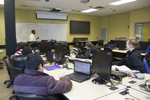 Analicia HonkenenNW David Konku teaches a class about financial equations in the College of Business Financial Trading Lab located in the upper level of the University Center. The grant will help buy updated supplied for the business department classrooms.