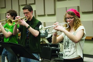 Senior music education major Robert Strieter (left), freshman mechanical engineering technology major Brad O’Hagan (middle) and freshman environmental science and history major Elizabeth Rogers (right) practice trumpet during the jazz band rehearsal.